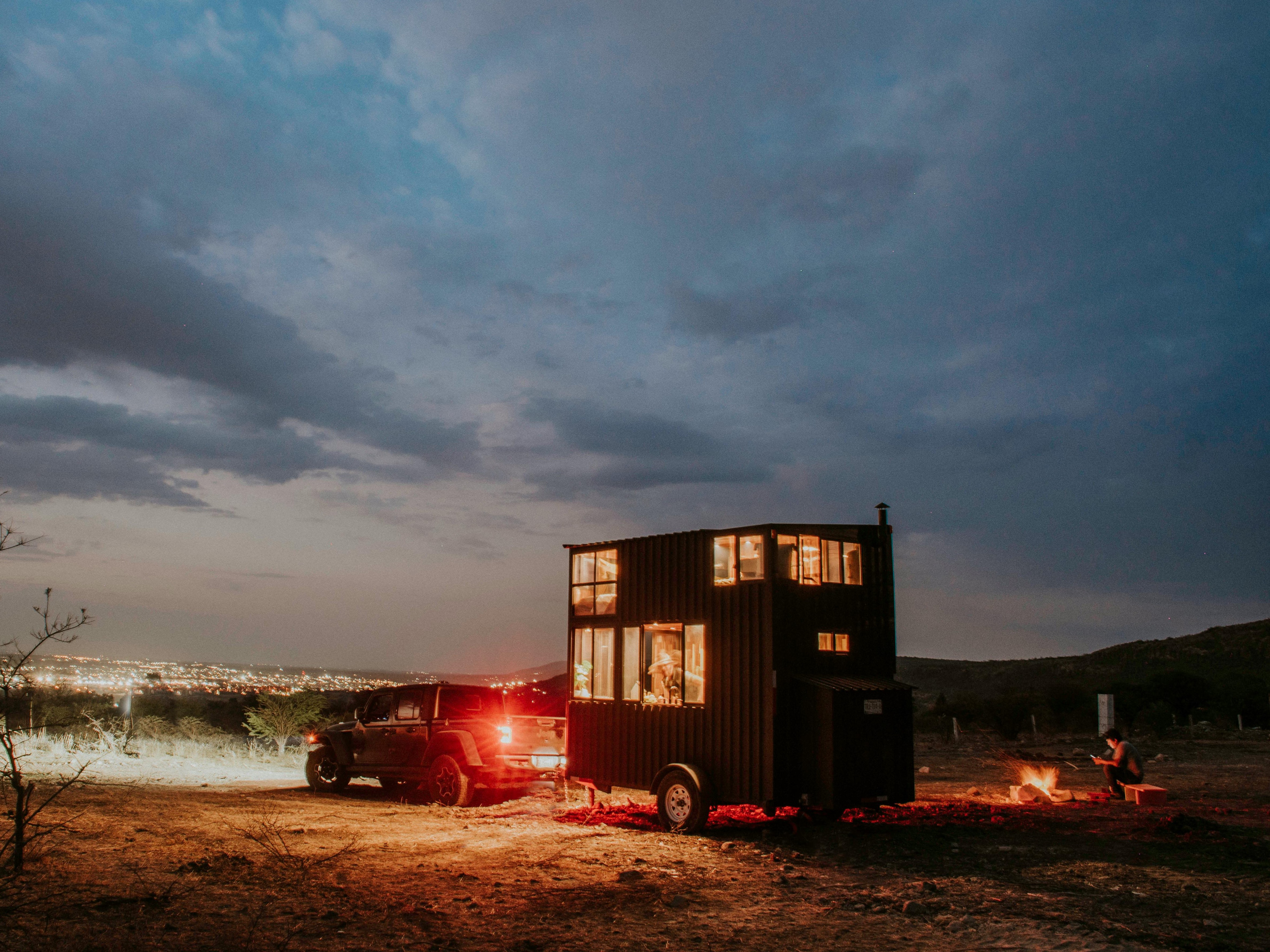 Car towing a tiny-house trailer